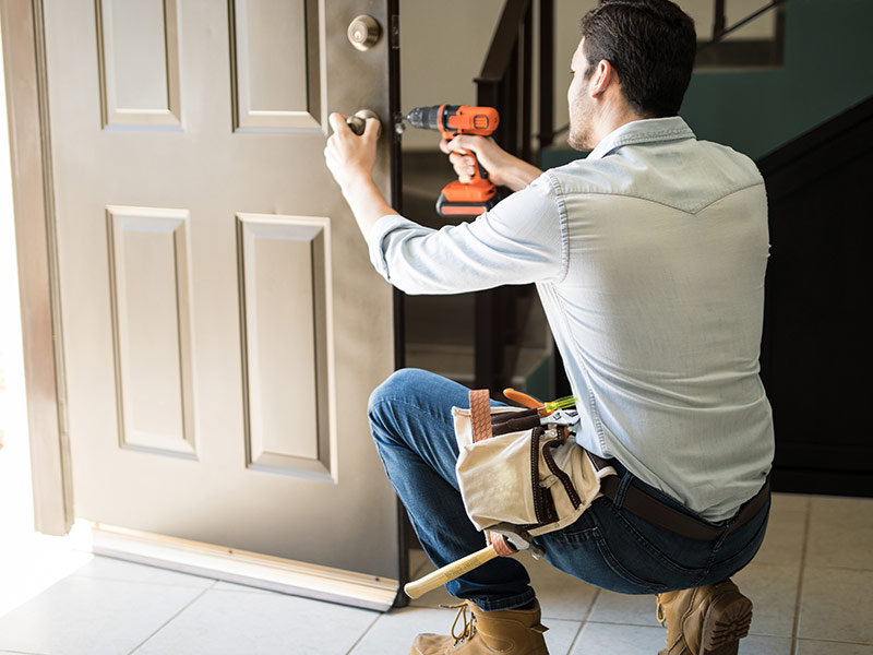 locksmith working on door